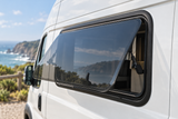 VanShade push-out window open for ventilation on a white campervan