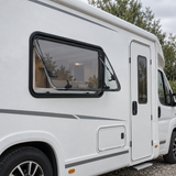 VanLight window installed on a flat motorhome wall — illustration